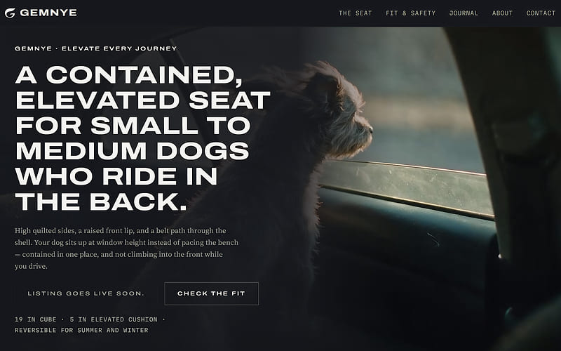 The Gemnye homepage on a desktop screen: a dark photograph of a small dog looking out of a car window, with the headline "A contained, elevated seat for small to medium dogs who ride in the back." and a "Check the fit" button over it.
